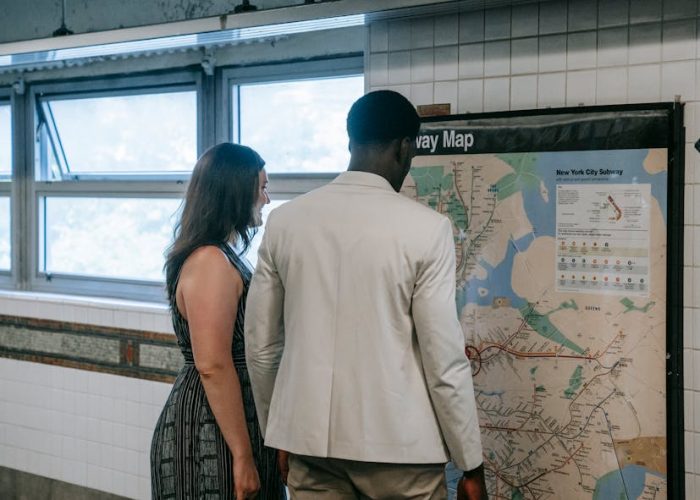 pexels-photo-8555076-8555076-1 Man and woman examining New York City subway map in subway station.